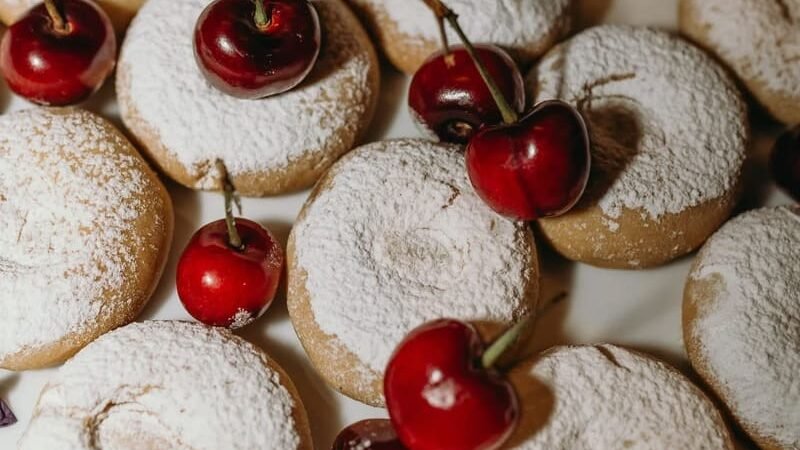 Chantel & May Photography captures detail shots of cherries and cookies styled as part of a wedding cake in South Africa.